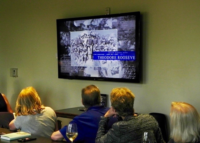 Pre-Launch Party-goers at Oxford Exchange watch a video trailer about 'Honoring the Enemy.'