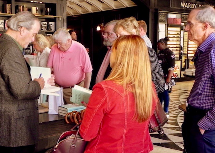 Cafe con Tampa patrons at Oxford Exchange buy copies of Robert Macomber's latest novel.