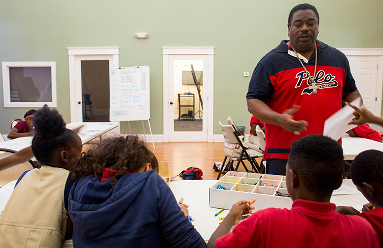 Andrew Joseph, a facilitator with the young adult group at THJCA, greets students.