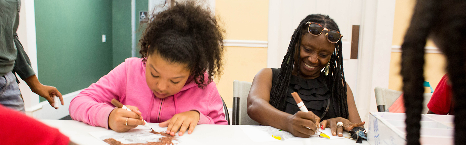 Sonia Coleman, right, works with students at the Tampa Heights Youth Development and Community Center.