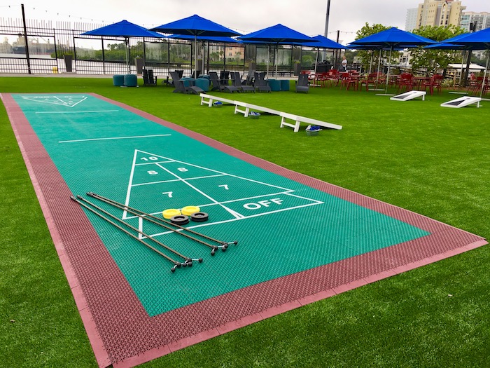 Outdoor shuffleboard and cornhole boards are part of the outdoor entertainment at Sparkman Wharf.