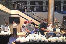 The Mahaffey Theater lobby is serving as a staging area for packing food for hungry kids.