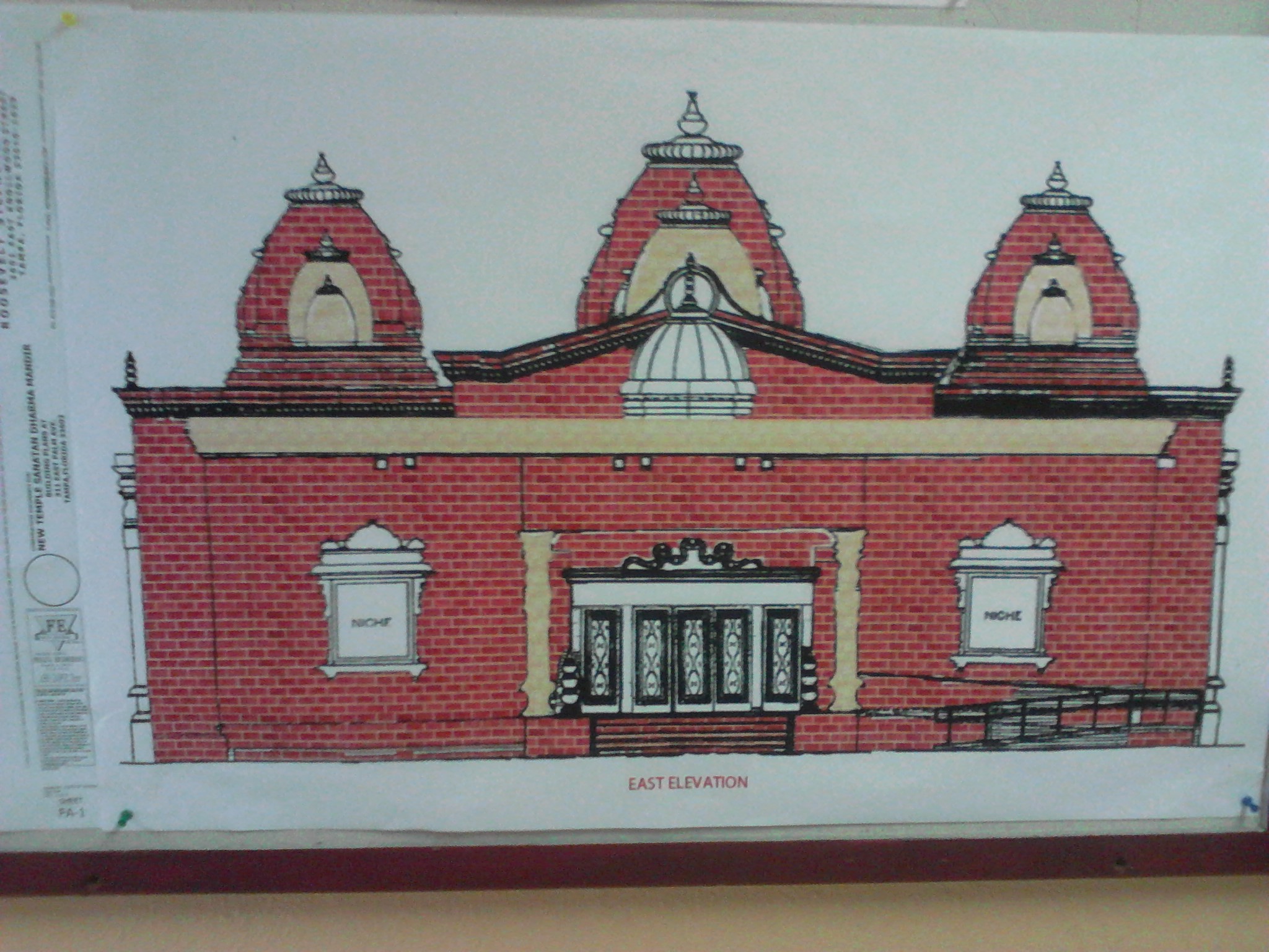 The facade of the new Hindu temple will be red brick and have five rising towers atop the roof.