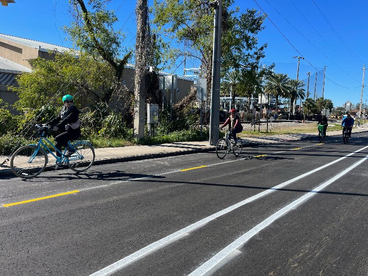 A group pedals along the newly paved cycle lane on Cass Street.