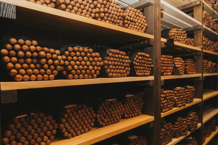 Cigars in neat stacks of 50 fill the shelves of the aging room in J.C. Newman's El Reloj factory.