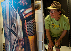 Steven Kenny checks out portrait photos by Lisa Presnail. 