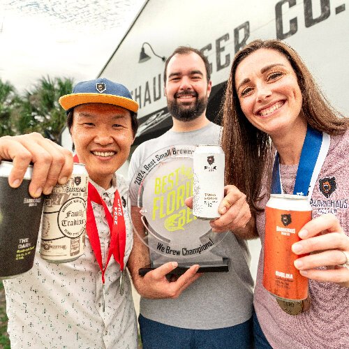 BarrieHaus co-founders Junbae Lee, Jim Barrie and Brittney Barrie raise a beer to the honor of winning Best Small Brewery of the Year in the 2024 Best Florida Beer Competition.