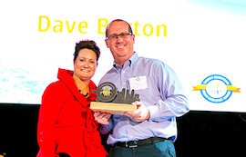 Tampa Downtown Partnership President and CEO Lynda Remund presents Person of the Year Award to businessman Dave Burton.