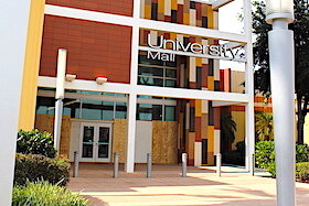 Boarded up windows at University Mall following looting.