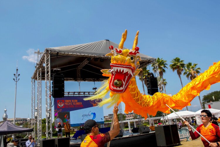 Members of the Suncoast Asian Cultural Association perform the Dragon Dance at the Tampa Asian Pacific Islander Cultural Festival at Curtis Hixon Waterfront Park.