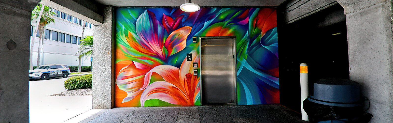 Muralist Dreamweaver brings life to the grey Municipal Parking Garage with her “Wild Flora” mural created for Clearwater's Art Oasis Mural Festival.