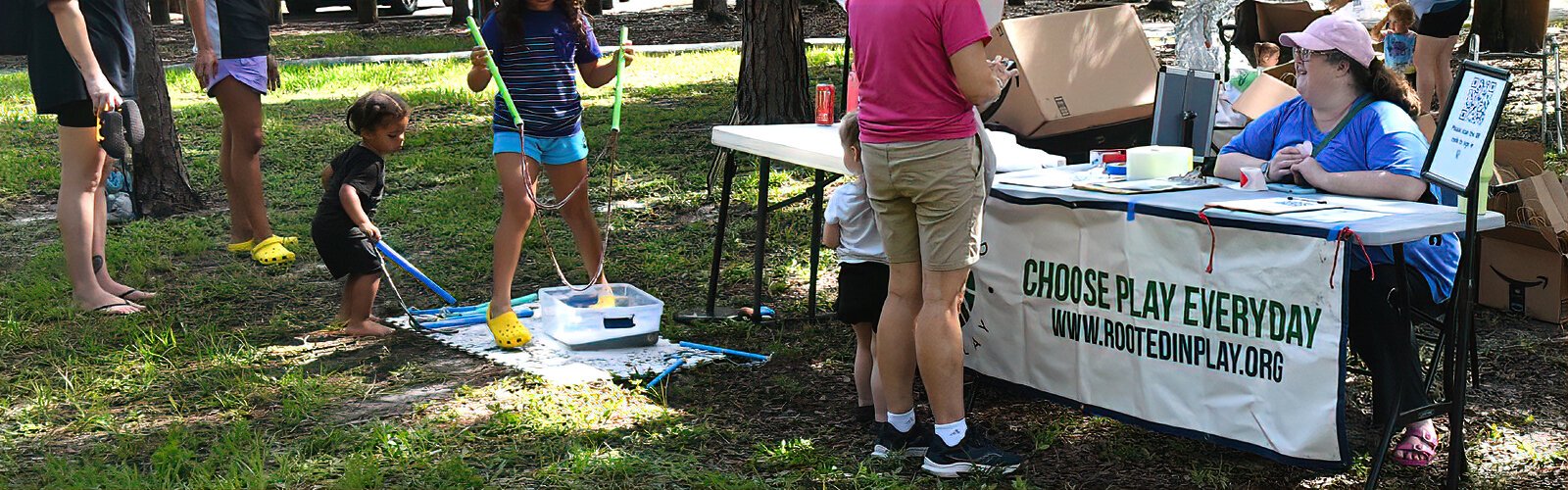 Rooted in Play board member Meghann Pabst works the registration table for the Mud Day adventure event at Rowlett Park in Tampa.