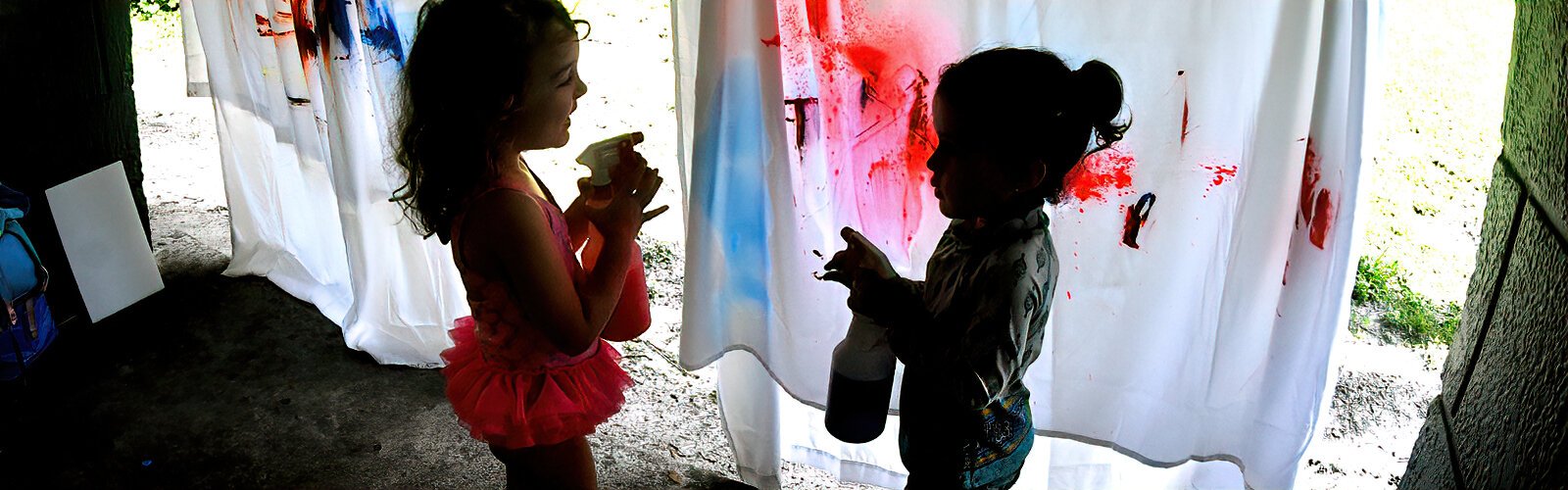 Eloise, 4, and Liana, 3, discover the joy of using spray paint.