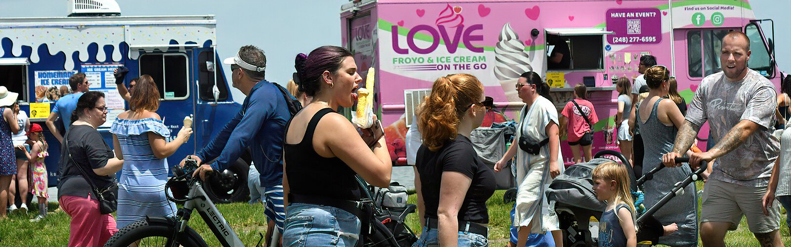 Surrounded by ice cream lovers, a festival goer indulges in a J-shaped Hawaiian honey cone at the Tampa Bay Ice Cream Festival.