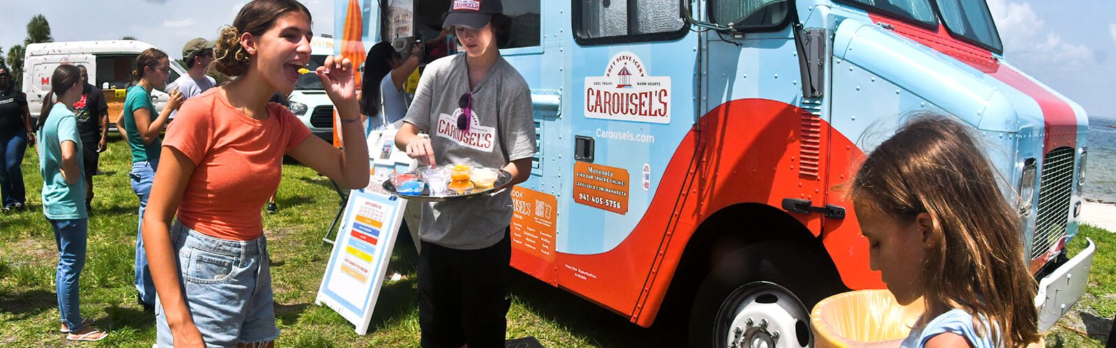 A festival-goer enjoys a sample of a dairy-free super creamy treat from Carousel’s Soft-Serve Icery.