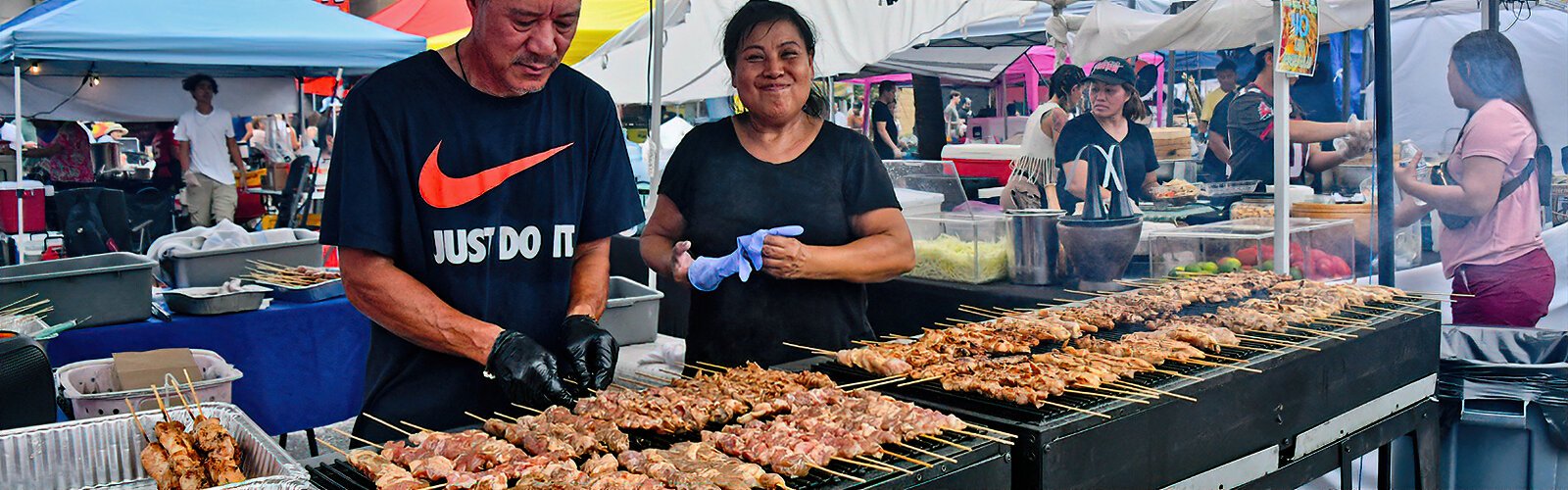  Savory meat skewers on the grill await hungry customers at the Asian Mega Night Street Food market.