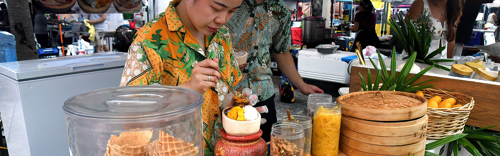 At Cococello 109’s booth, a Thai coconut ice-cream dessert is specially handcrafted in a coconut shell for a customer.