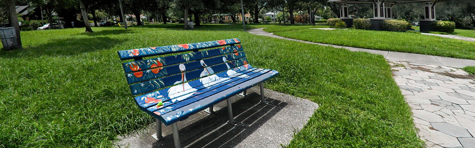 Funded by Dining for Art fundraising events and city matching grants,  Kenwood’s Artist Enclave’s ambitious public art program includes bench art, street corner finials and banners.