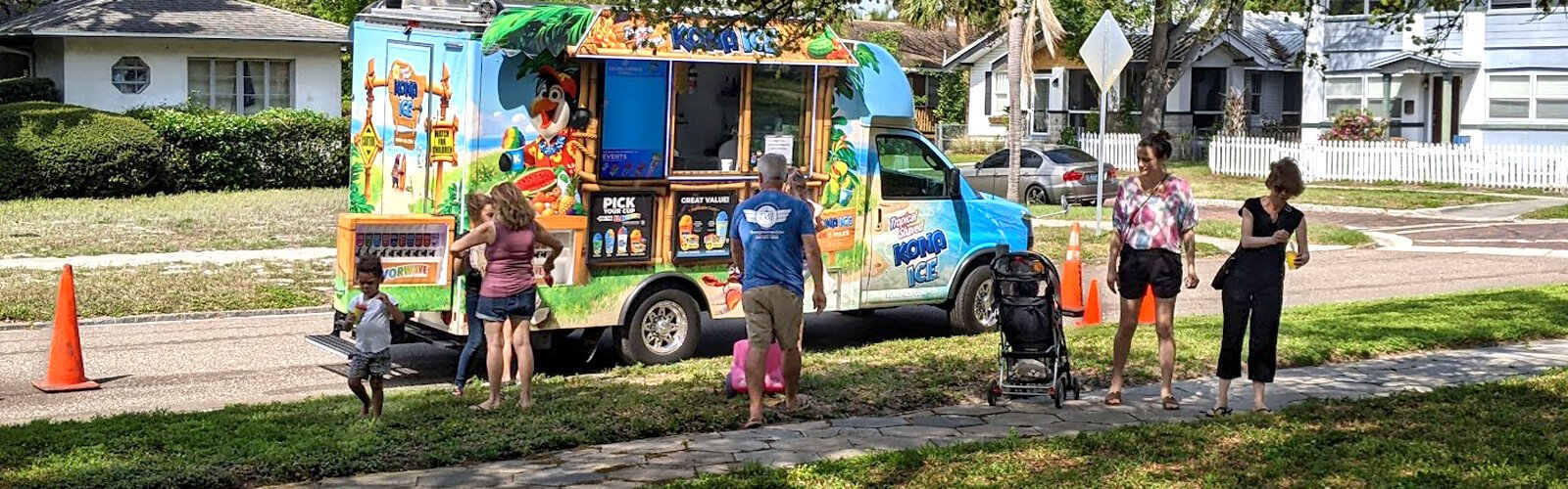 A Kona Ice truck spreads coolness and smiles during Historic Kenwood Founders Day by offering free snow cones to neighbors and visitors.