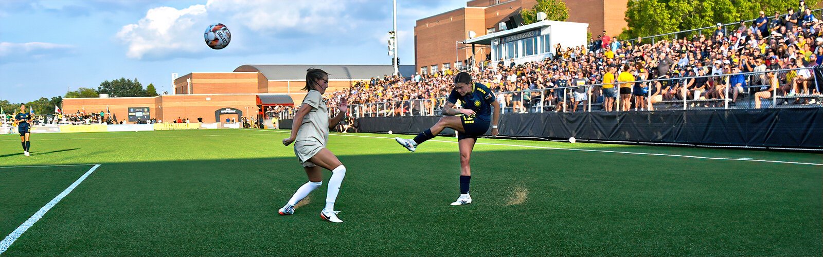 Sun FC forward Ashley Clark passes the ball across the pitch to her teammates.