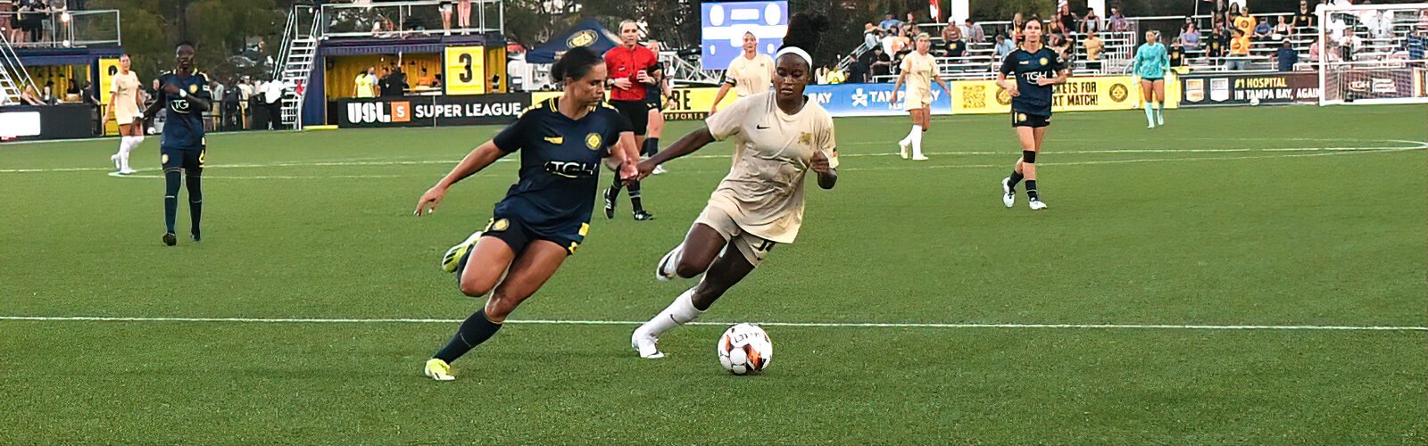 Sun FC midfielder and USF record-holder Jordyn Listro and Dallas Trinity FC midfielder Chioma Ubogagu vie for possession.