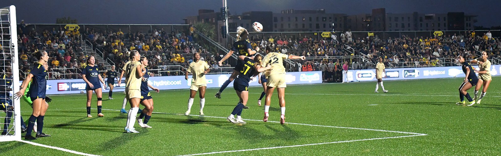 Sun FC defender Brooke Hendrix jumps for a header.