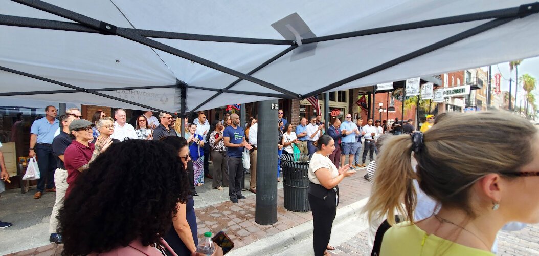 The crowd lined the sidewalk to celebrate East Seventh Avenue's return to brick