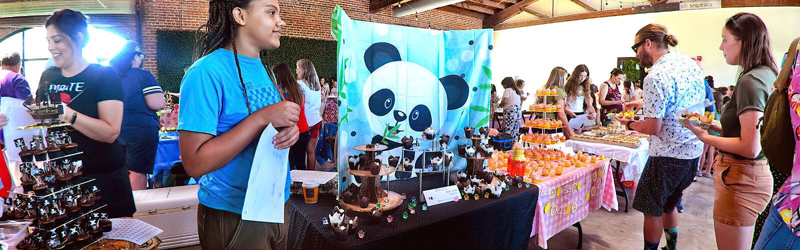 A cute panda display helps Hazel Cook attract attendees to her sweet treats at the Great St Pete Cupcake Contest