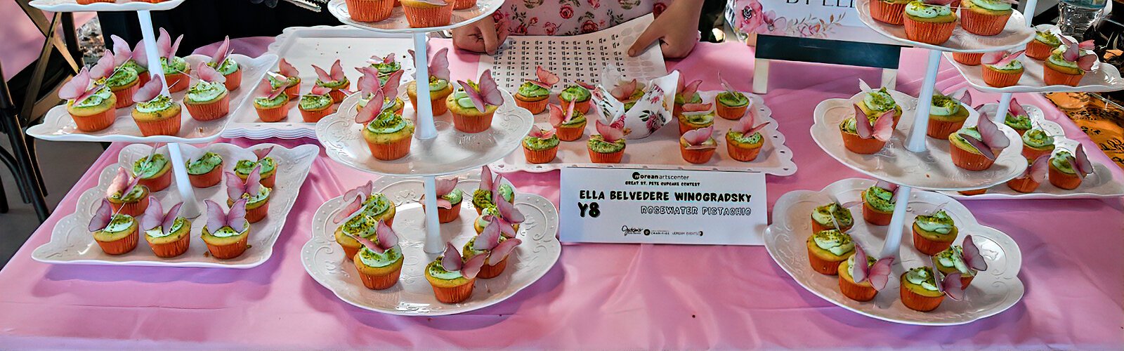  The “Rosewater Pistachio Cupcakes by Ella” are beautifully topped with edible butterfly decorations.