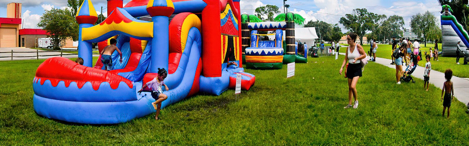  A  bounce house water slide provides a refreshing respite from the heat of the day at the Suncoast Kids Extravaganza.