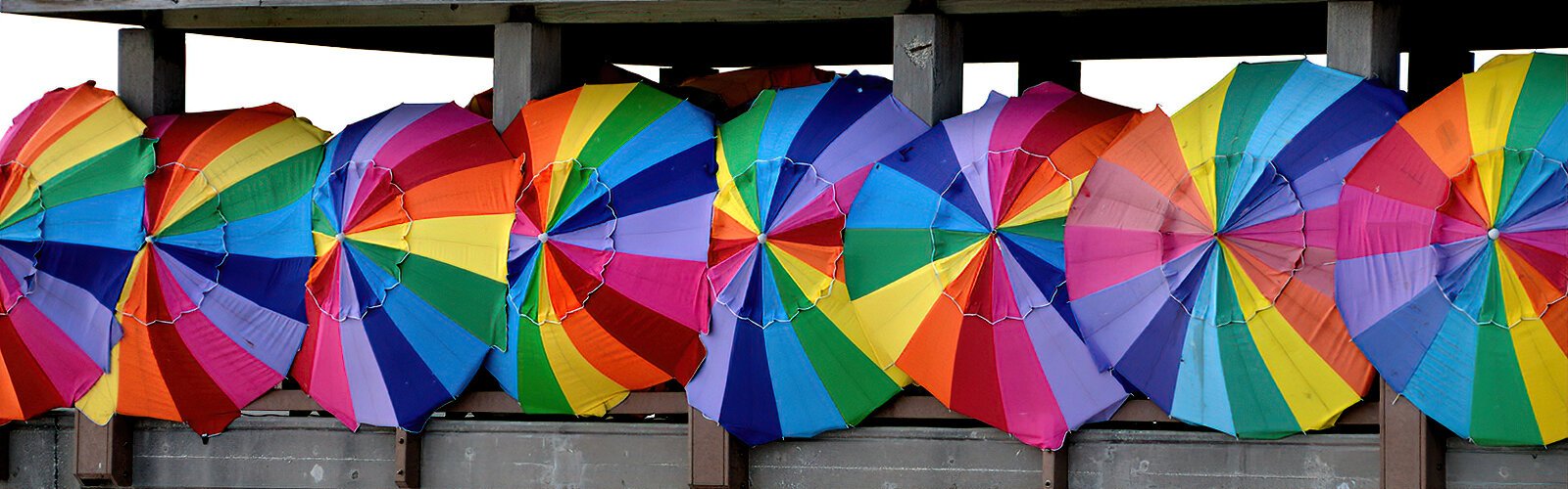 Colorful umbrellas protect vendors selling handcrafted goods from the sun at Clearwater Beach's Pier 60.