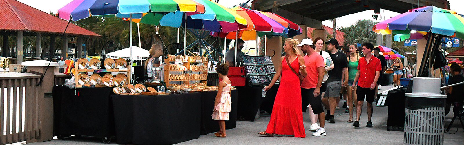 People browse among the local vendors who sell their crafts, plants and souvenirs every afternoon and evening at Pier 60.