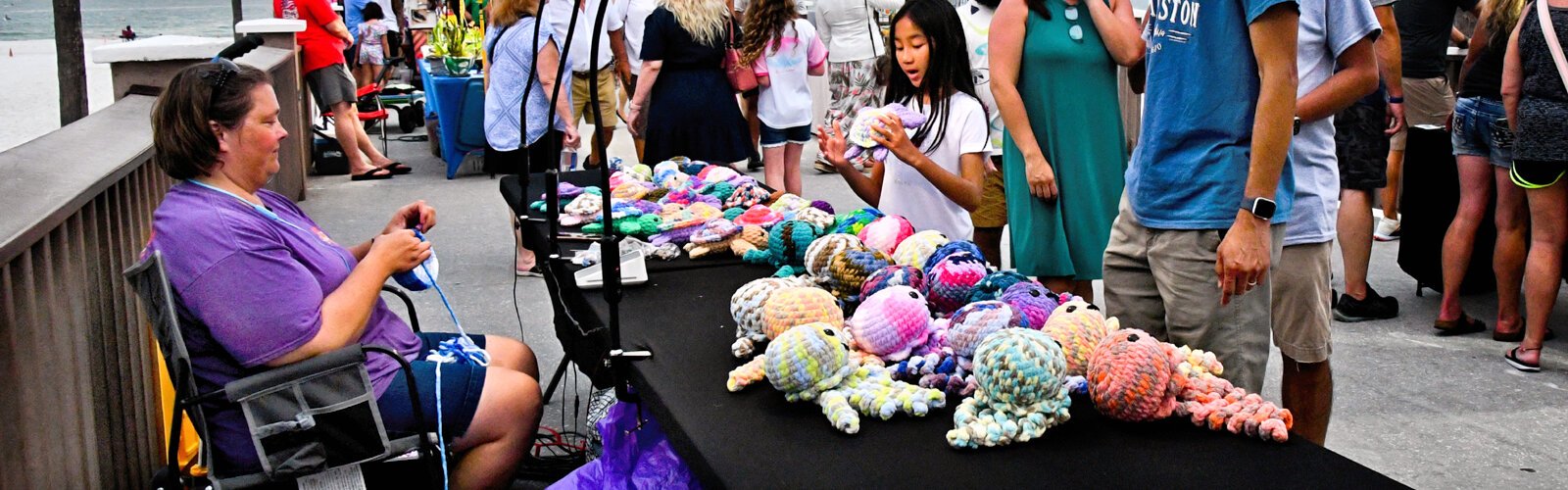 A young girl finds something to treasure with a crochet turtle from Chickadee Yarnworks.