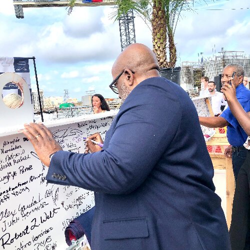 St. Petersburg Mayor Ken Welch and State Senator Darryl Rouson sign the beam that will be raised into place during the topping out ceremony for The Residences at 400 Central.