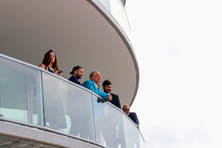 Red Apple Group founder and CEO John Catsimatidis Sr. and his family look out from a balcony at The Residences at 400 Central.