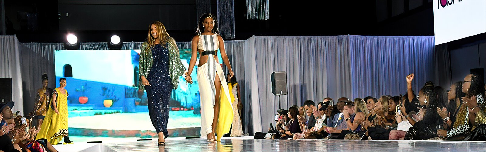  Lead designer Elizabeth Carson Racker takes the runway with her models following the presentation of her collection at the 17th annual Tampa Bay Fashion Week.