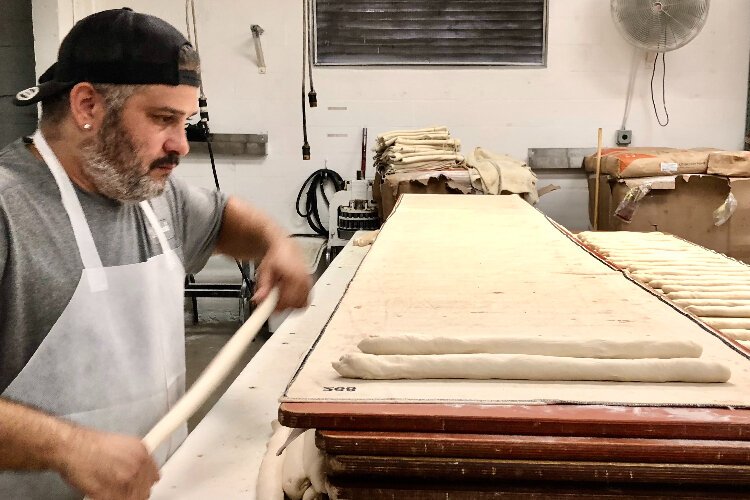 La Segunda Central Bakery's Anthony Ali shapes dough into loaves at the 110-year-old bakery and Tampa institution.