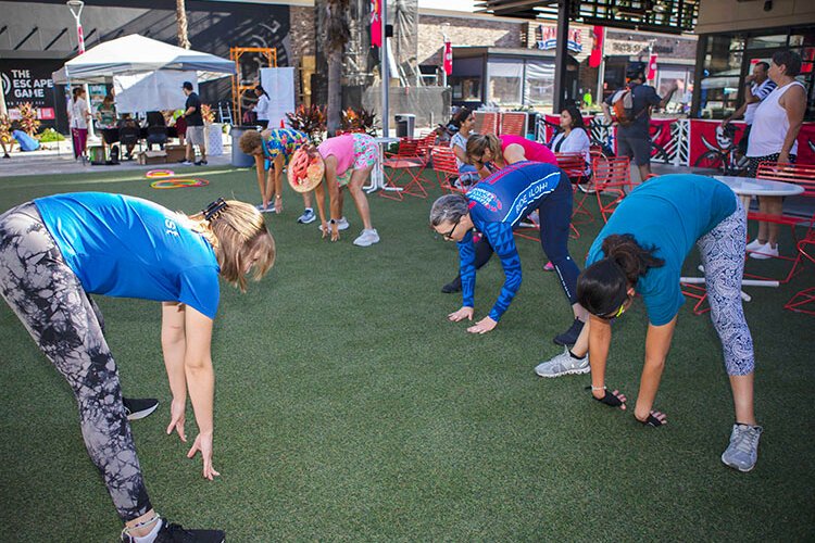  Fitness instructors from the Shanna and Bryan Glazer JCC lead a stretching session at Midtown Commons in the Westshore district, one of three activity hubs on Tampa's 2nd annual World Car-Free Day.