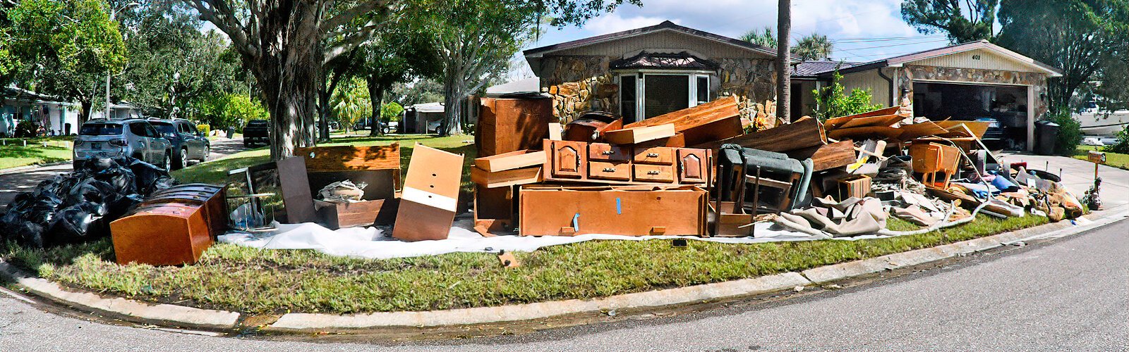 amaged and discarded Items and furniture from homes flooded by Hurricane Helene’s storm surge are piled by the curb in St Pete’s Shore Acres neighborhood.