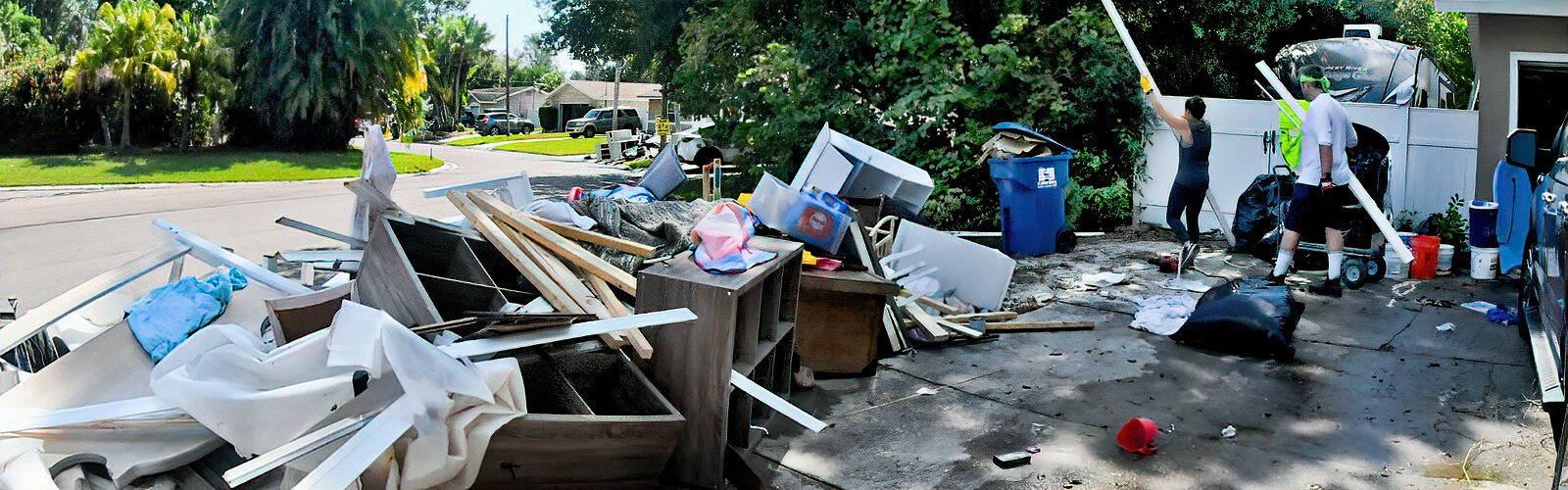 Items damaged by the floods are discarded by helpers at resident Zachary Ripley’s house in Shore Acres.