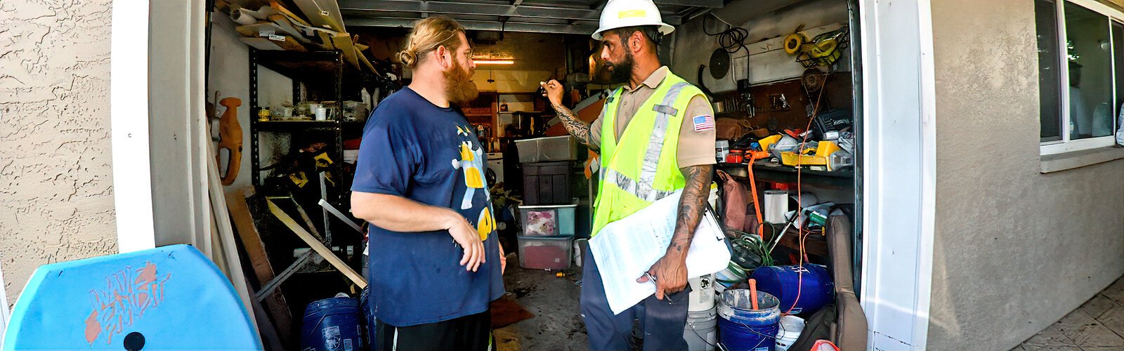 TECO technician Frankie Pijuan talks with Zachary Ripley after checking his house for gas leaks in the aftermath of Hurricane Helene.