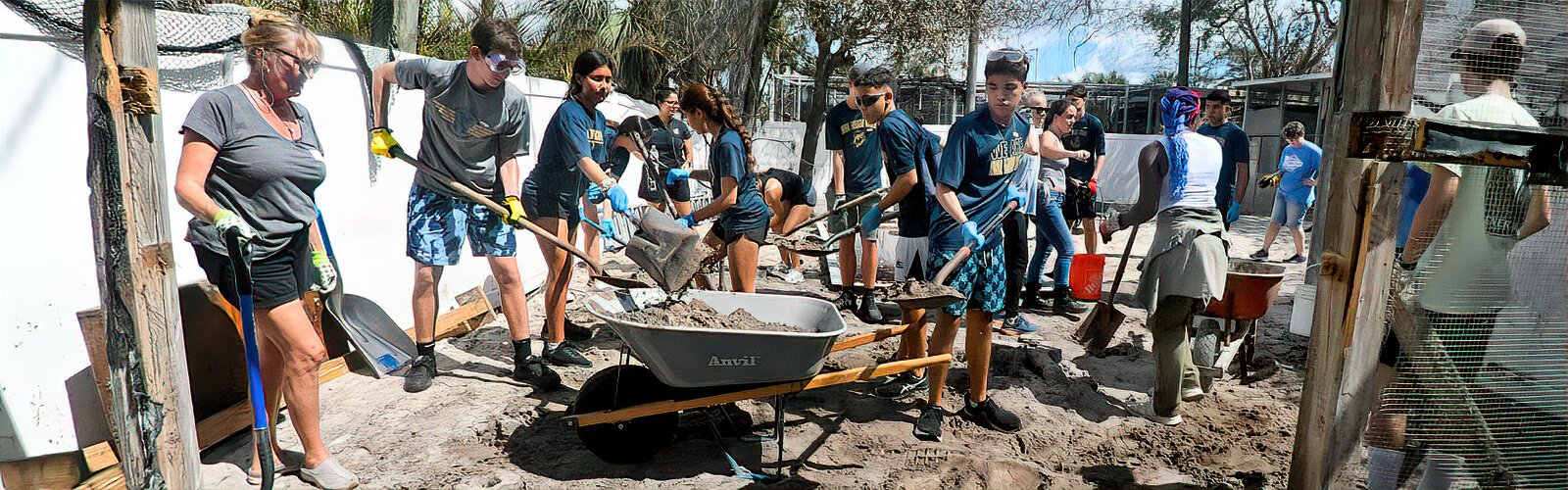 Admiral Farragut Academy students actively volunteer to shovel off layers of sand brought into enclosures by Hurricane Helene