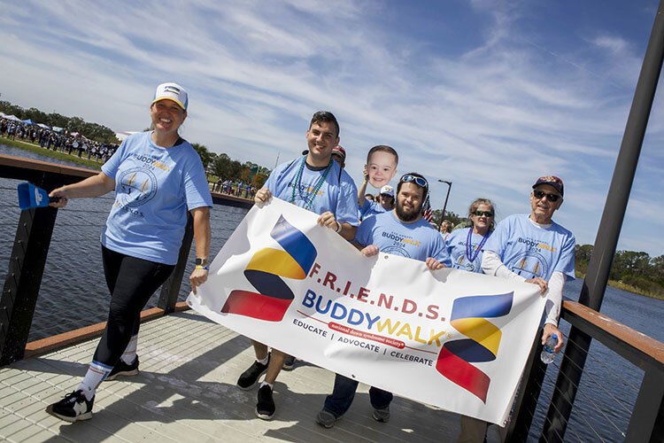 Ashley Piazza Odom, executive director of F.R.I.E.N.D.S. Down Syndrome Special Needs, leads hundreds of participants in the eighth annual Buddy Walk at Carrollwood Village Park.