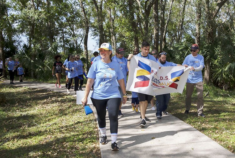 Ashley Piazza Odom, executive director of F.R.I.E.N.D.S. Down Syndrome Special Needs, leads hundreds of participants in the eighth annual Buddy Walk at Carrollwood Village Park.