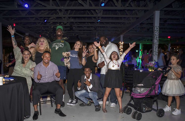 Mark Oliver (second from left) and members of his Specially Fit Foundation celebrate at the Kristin Tomasello Foundation's "A Night to Remember" special needs prom at ZooTampa.