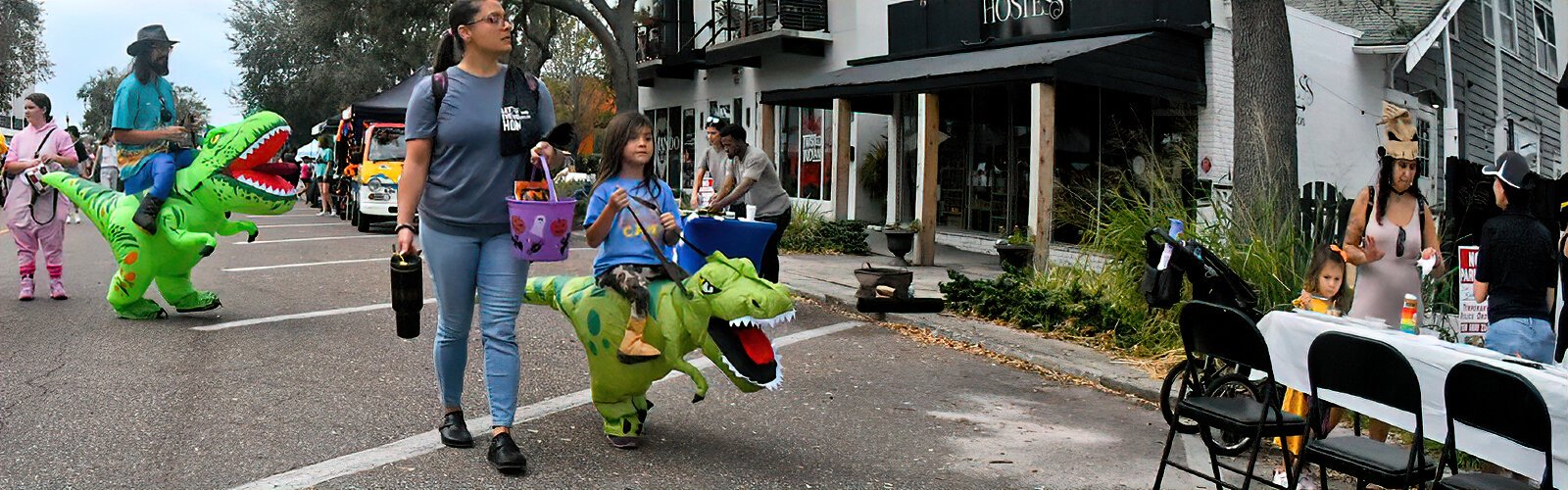 With 22 blocks of Central Avenue closed to traffic, festival goers proudly march in their inflatable dinosaur costumes during Halloween on Central