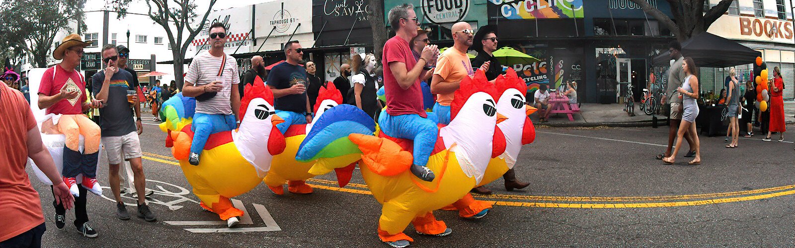 A flock of colorful inflatable roosters goes down car-free Central Avenue to celebrate Halloween.