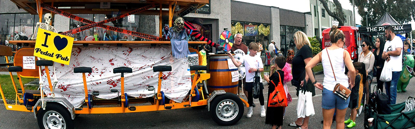 Prizes and candies are handed to children after they spin the wheel at the PedalPub Party Bus during Halloween on Central. 