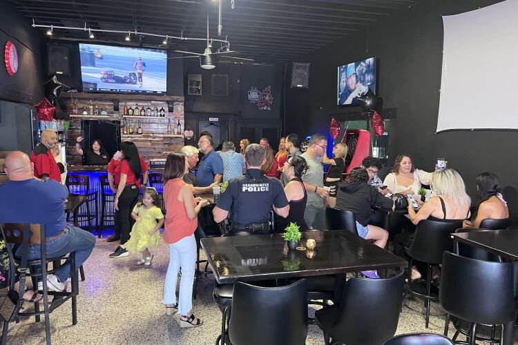 45 Sports Bar & Grill staff, family, friends and city officials after the business' ribbon-cutting ceremony in July.