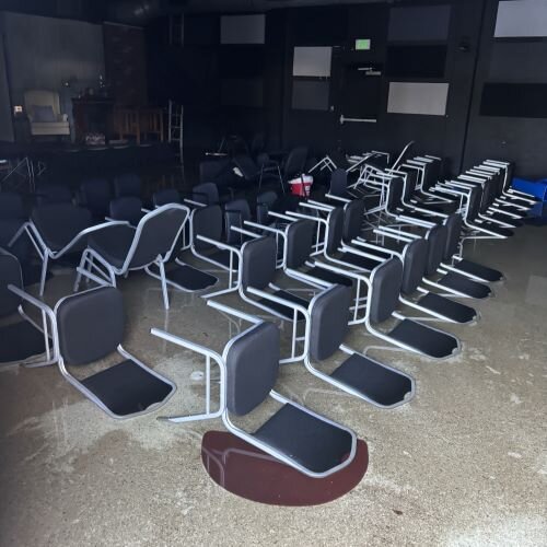 Helene flooded the theater at Firehouse Cultural Center in Ruskin and left the chairs set out for a production of "Dial M for Murder" laying on their backs.